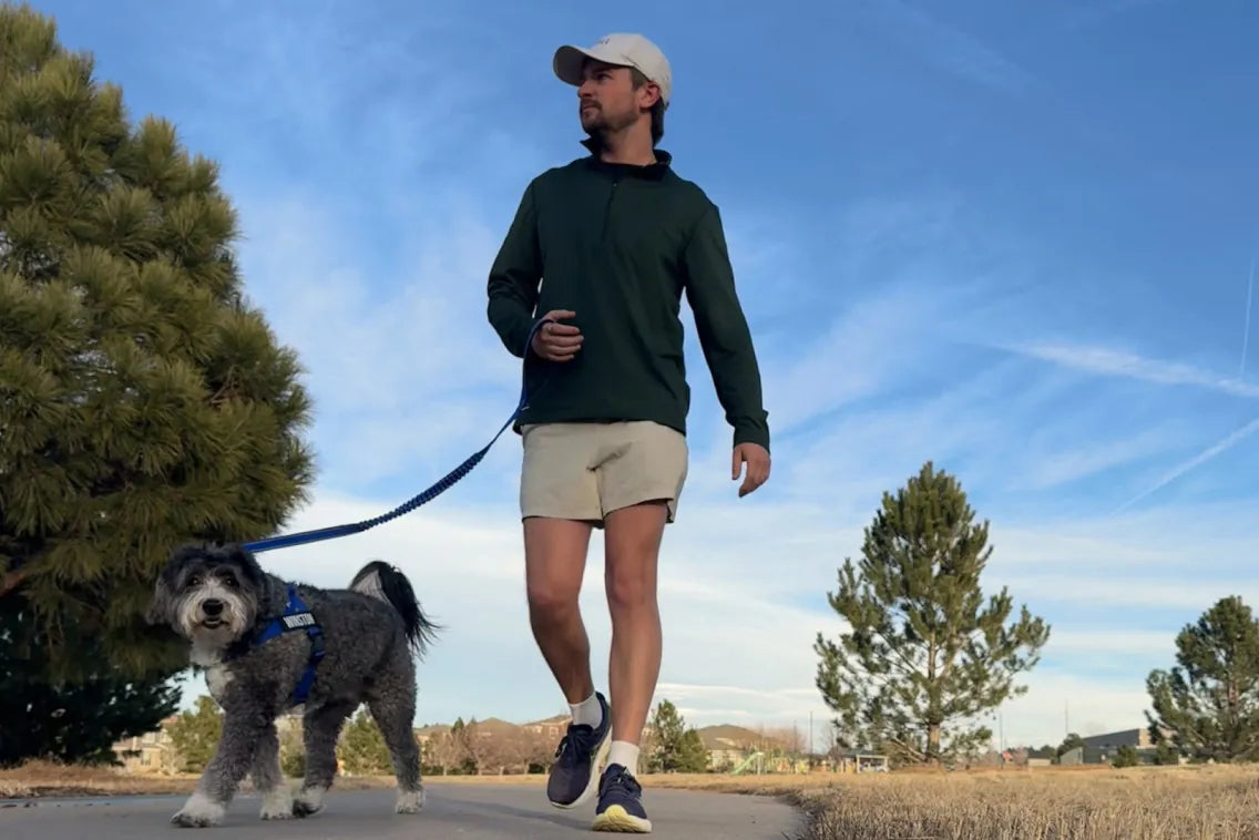 Tanner walking Winston on a trail